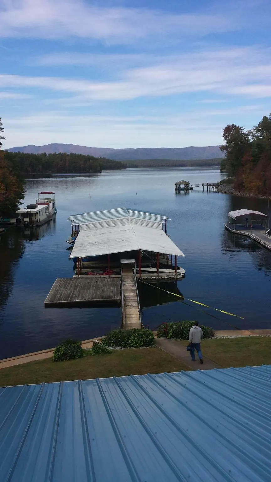 View across a lake from a newly installed blue metal roof in Georgetown
